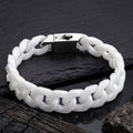 A white Jade cuban-link bracelet with a silver-toned padlock clasp, displayed on a dark slate surface.